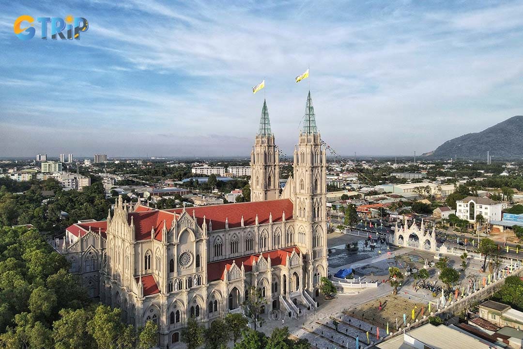 The striking Song Vinh Church immediately impresses with its massive white Gothic facade, towering 45-meter bell towers, pointed arches, ornate spires