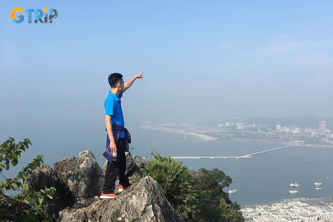 The summit of Poem Mountain offers stunning views of Ha Long Bay, with emerald waters, limestone islets, and floating villages