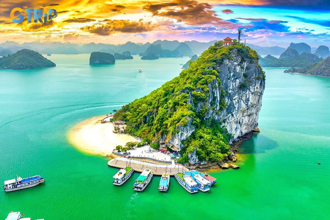 Titop Island offers a white sandy beach, a 360-degree view of Ha Long Bay, and activities like swimming, sunbathing, and photography