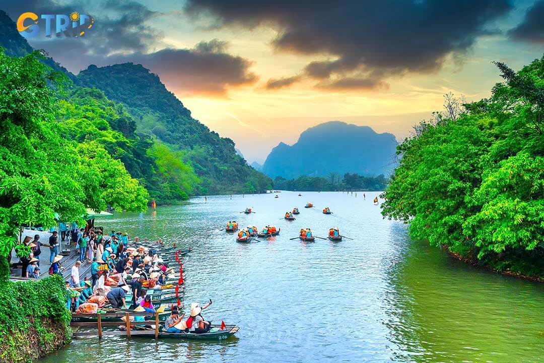 Tourists float by boat on the river of the Tam Coc