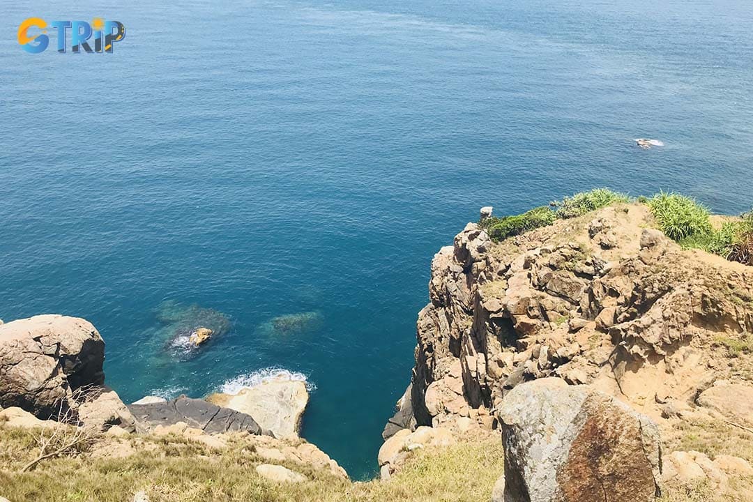 Trek to Nghe Cape for a rugged coastal hike featuring rocky trails, a hidden natural pool, and spectacular sunrise views over the ocean