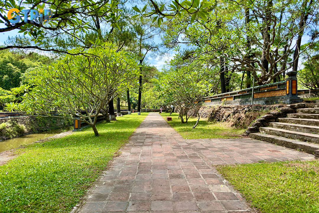 Tu Duc Tomb is enveloped by a lush canopy of trees, creating a refreshing and peaceful retreat