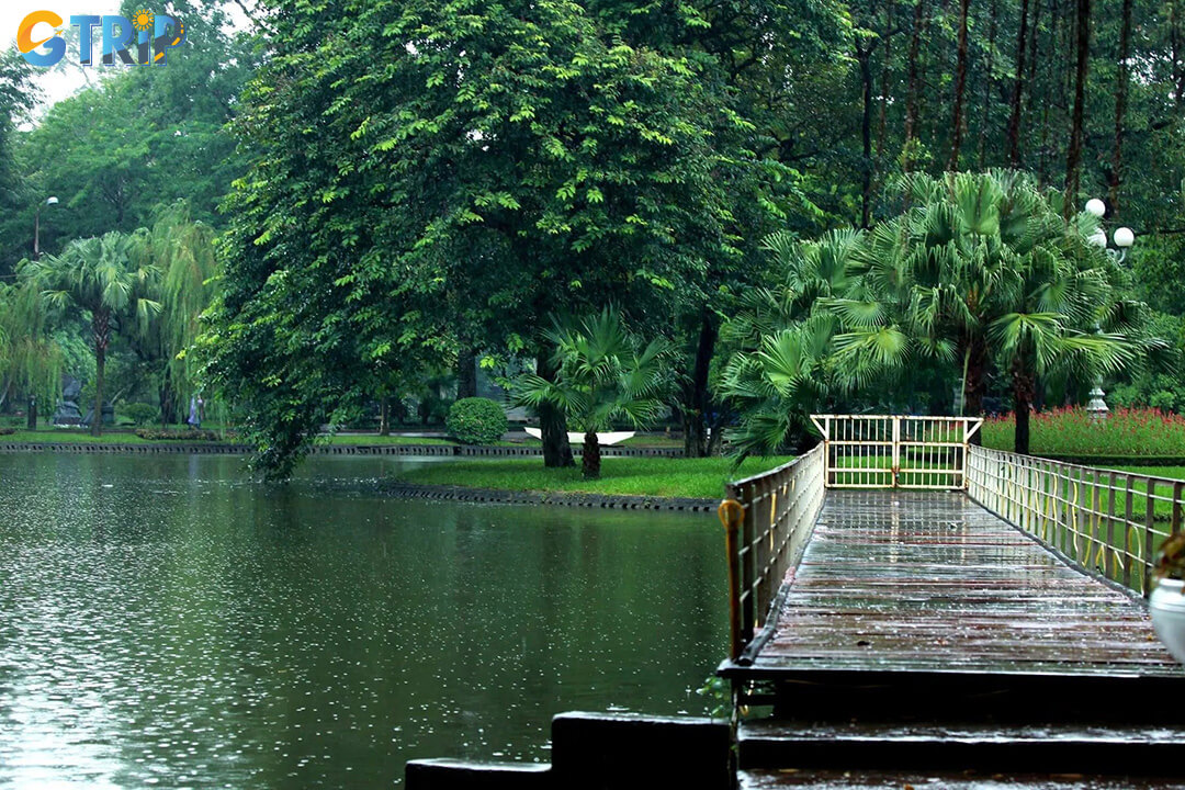 Vi Danh Lake, the tranquil heart of the park, offers scenic views, a charming bridge, and a peaceful setting for walks and quiet moments