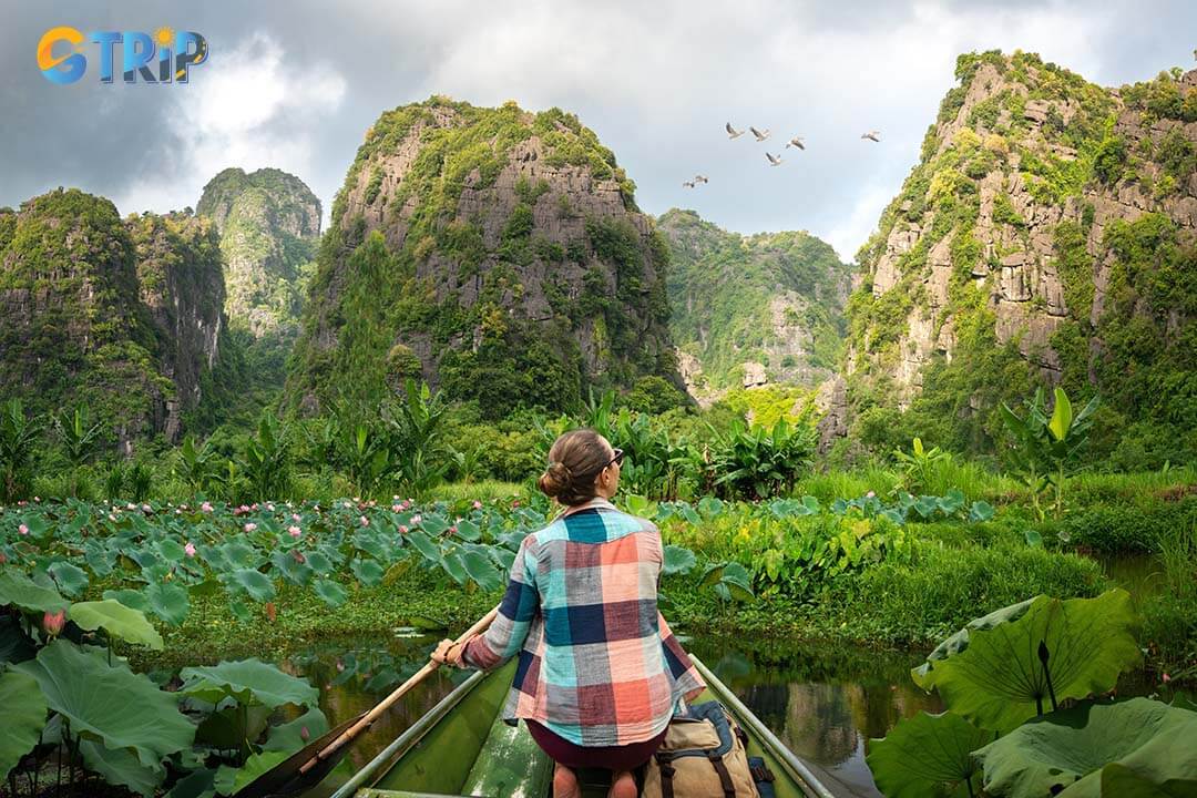 Woman with backpack travels along river in boat