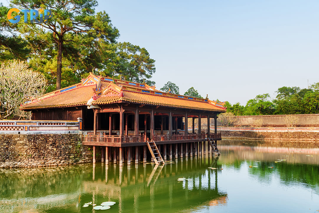 Xung Khiem Pavilion is a wooden structure overlooking a tranquil lotus pond